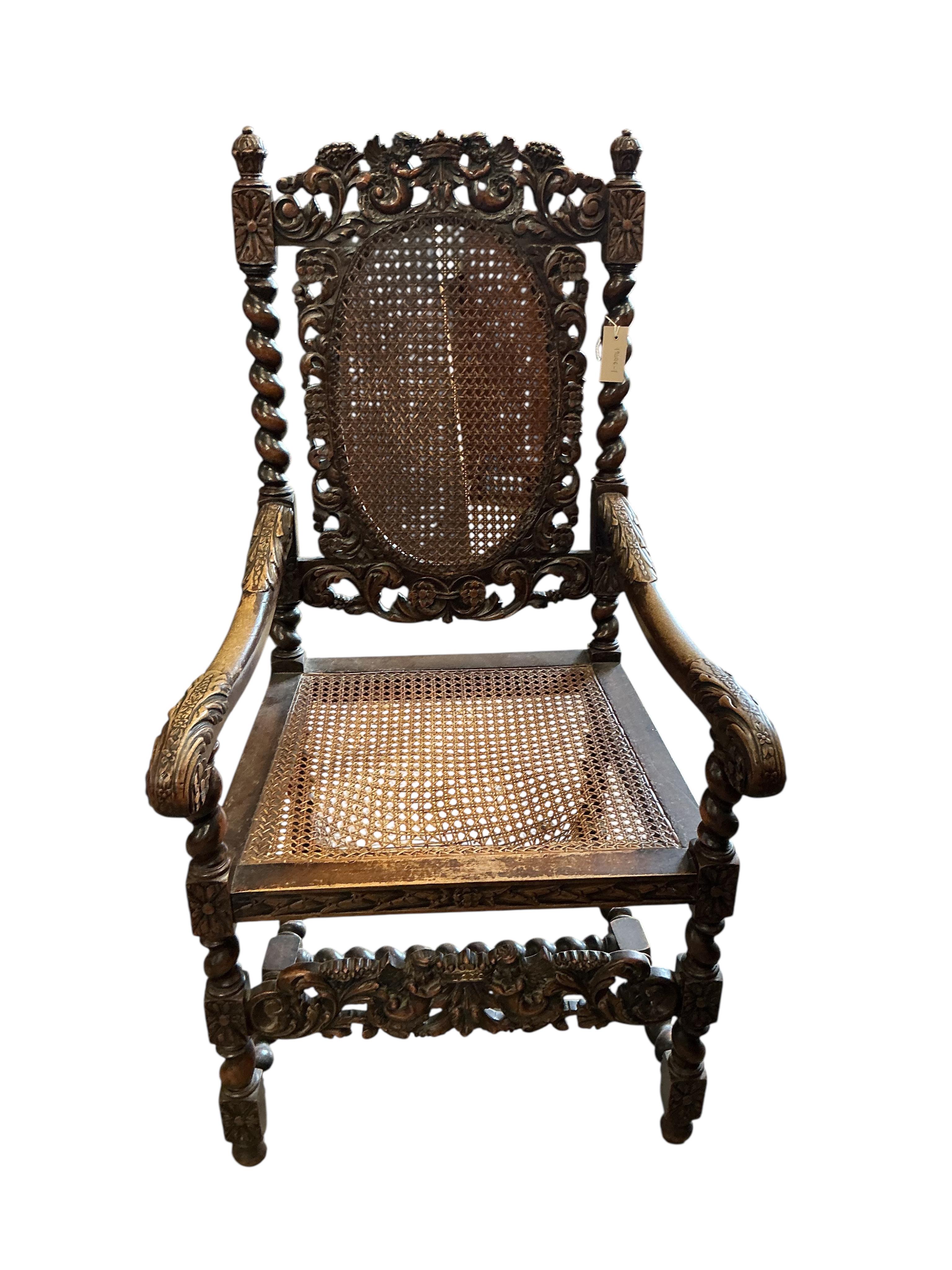 A Carolean style caned carved walnut elbow chair, width 61cm, depth 51cm, height 114cm